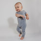 Little girl walking around wearing a grey Bamboo Lyocell Zipease Romper