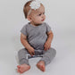 Little girl sitting on the floor wearing a grey Bamboo Lyocell Zipease Romper