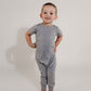 Little boy posing wearing a grey Bamboo Lyocell Zipease Romper