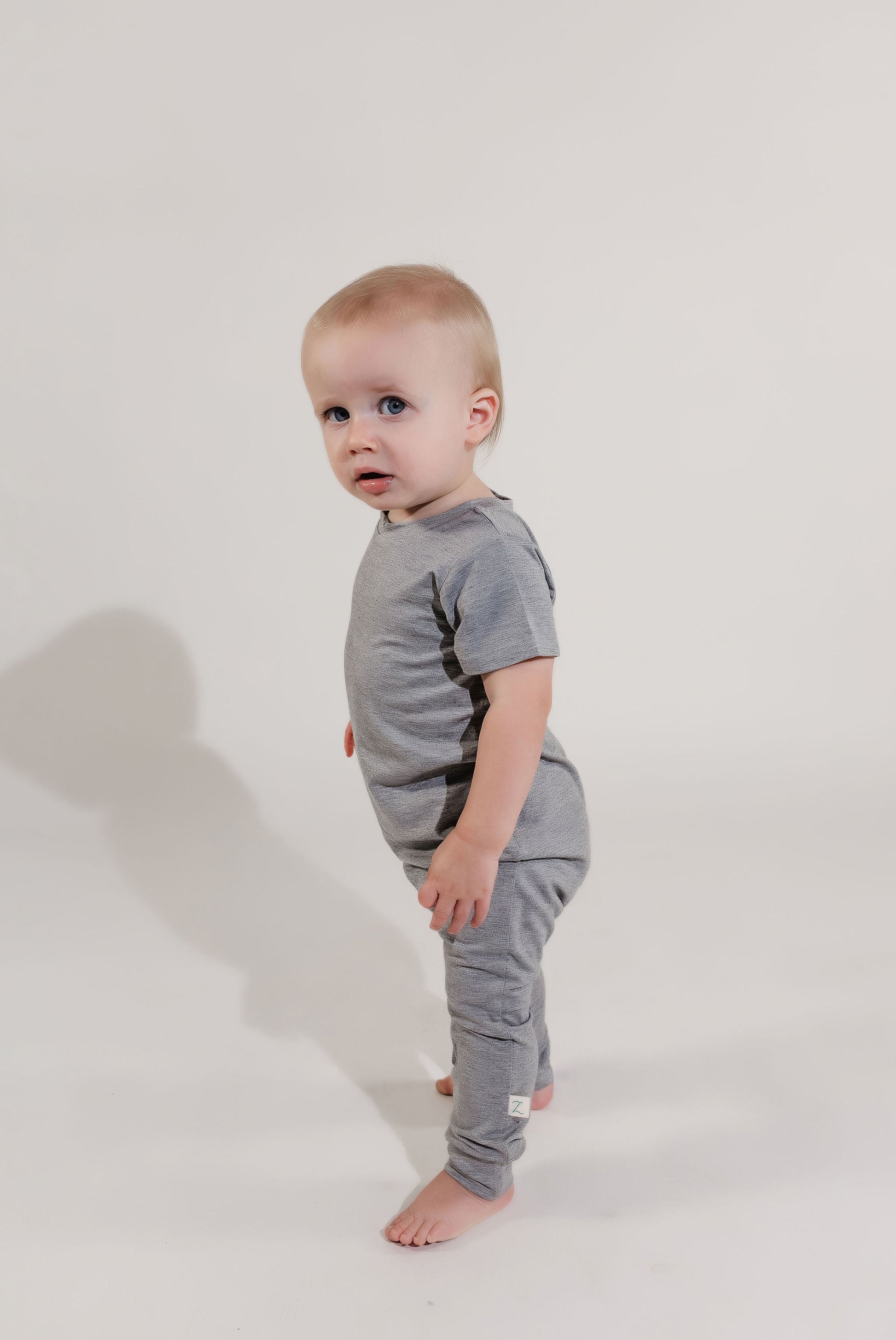 Little boy wearing a grey Bamboo Lyocell Zipease Romper