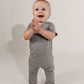 Little boy walking around clapping wearing a grey Bamboo Lyocell Zipease Romper
